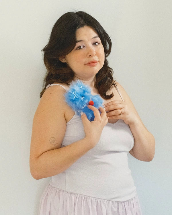 Kiki holding a blue doll